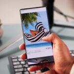 a man scrolling through travel posts on social media, deciding where to go, which is step one on our international travel checklist