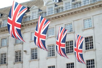 flags hanging in front of UK healthcare building