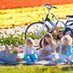 children sitting in a tulip field in the Netherlands, one of the best places to raise a family