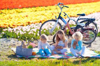 children sitting in a tulip field in the Netherlands, one of the best places to raise a family