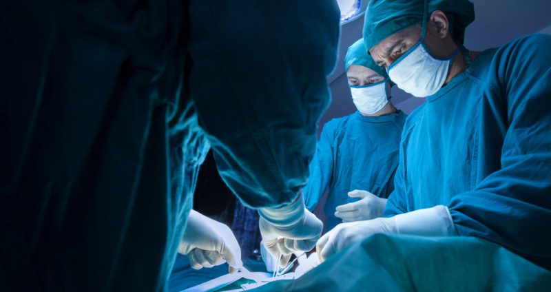 Surgeons operating on an expat