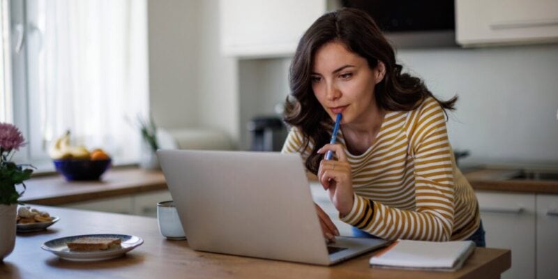 a woman applying for the UK ETA on her laptop at home