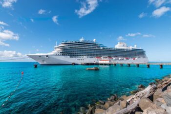 Oceania Vista cruise ship docked in Roseau, Dominica, where passengers are enjoying their trip having read the best cruise tips
