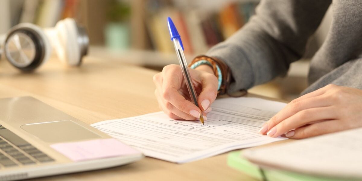 a student filling in paperwork early, one of the most important study abroad tips