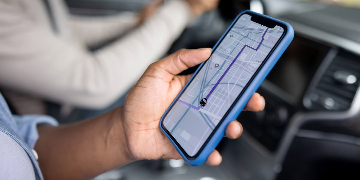 a close-up of a person using a rideshare app, one of the top study abroad safety tips to follow