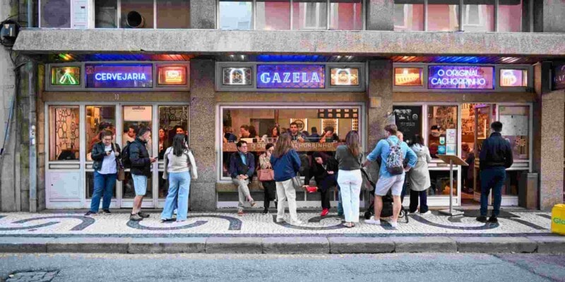 people drinking outside a snack bar in Porto, Portugal