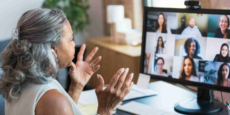 a team leader having an online meeting with collegues, having researched how to manage a remote team successfully across borders 