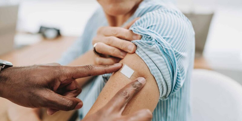 a woman getting vaccination before traveling to Portugal