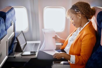 a woman on a plane, indicating an employee relocation overseas