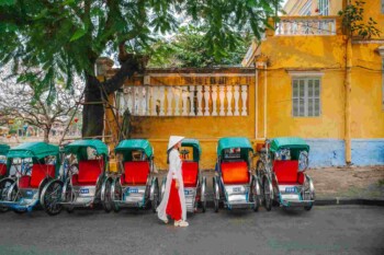 a woman walking in a street in Hoi An, Vietnam, one of the cheapest countries to live in