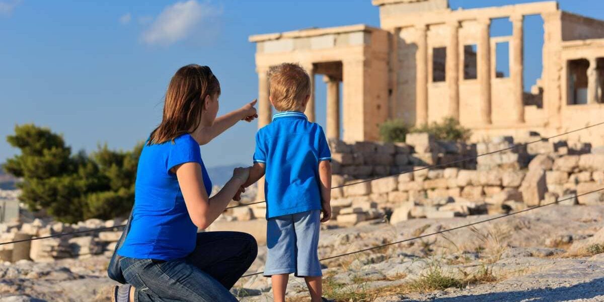 a mother and son looking at the Acropolis in Athens, Greece, one of the best family vacation ideas for 2025
