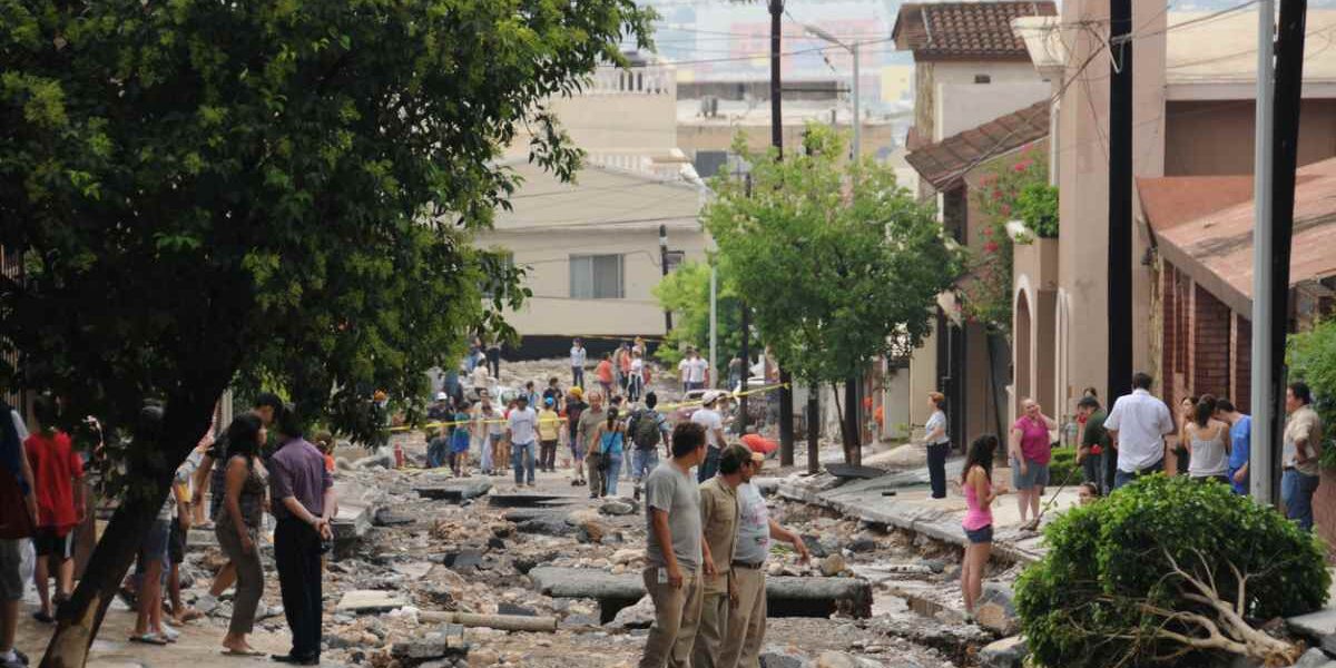 damage to a street and cars after Hurricane Alex in Monterrey Mexico, where tourists are advised to buy travel insurance for Mexico