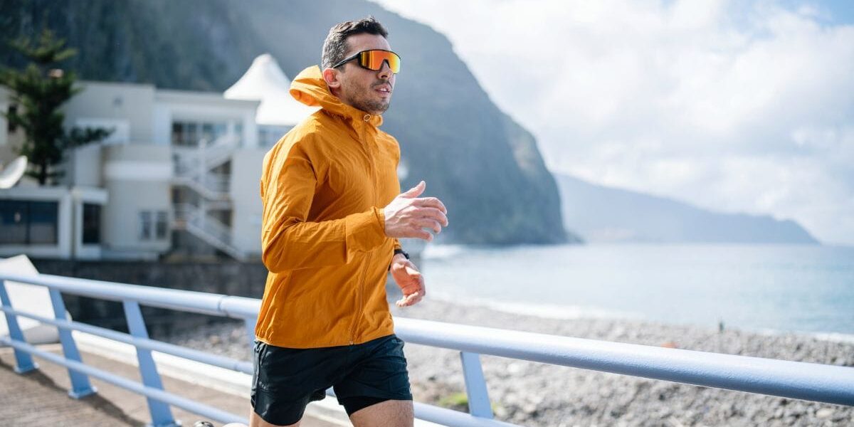 a man jogging in the sun, wearing UV protection sunglasses, one of the best skin care tips for expats