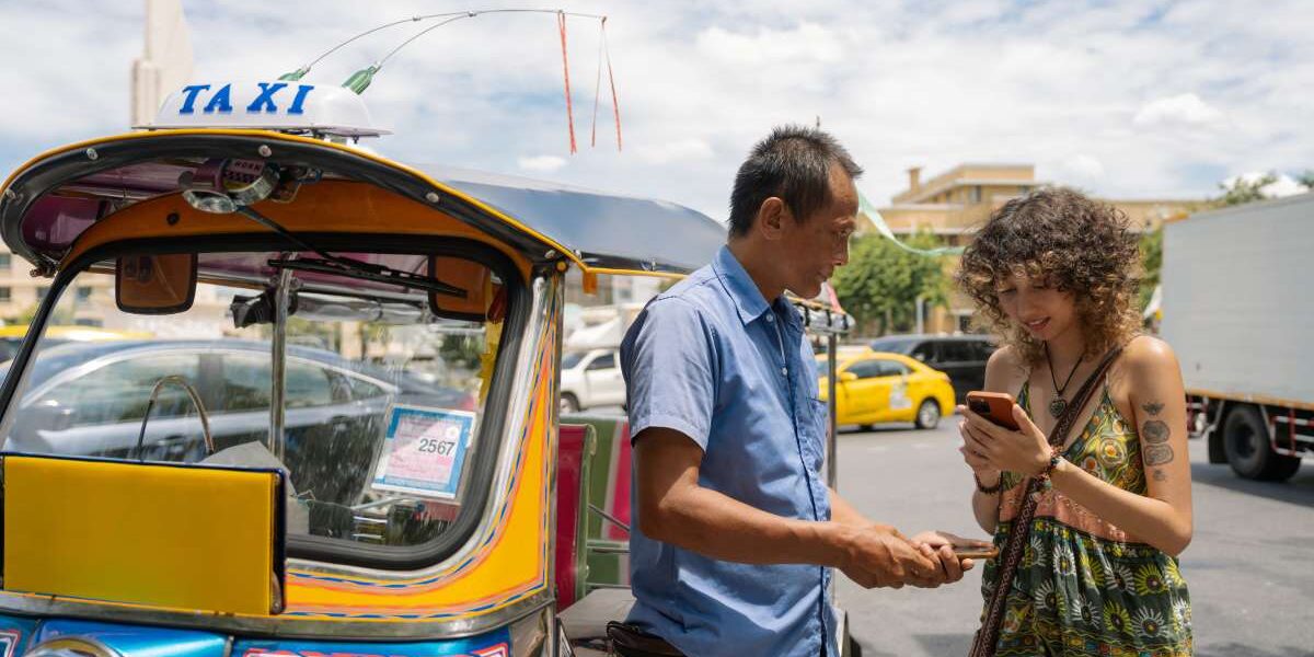 a female traveler trying to avoid one of the common tuk tuk travel scams in Thailand