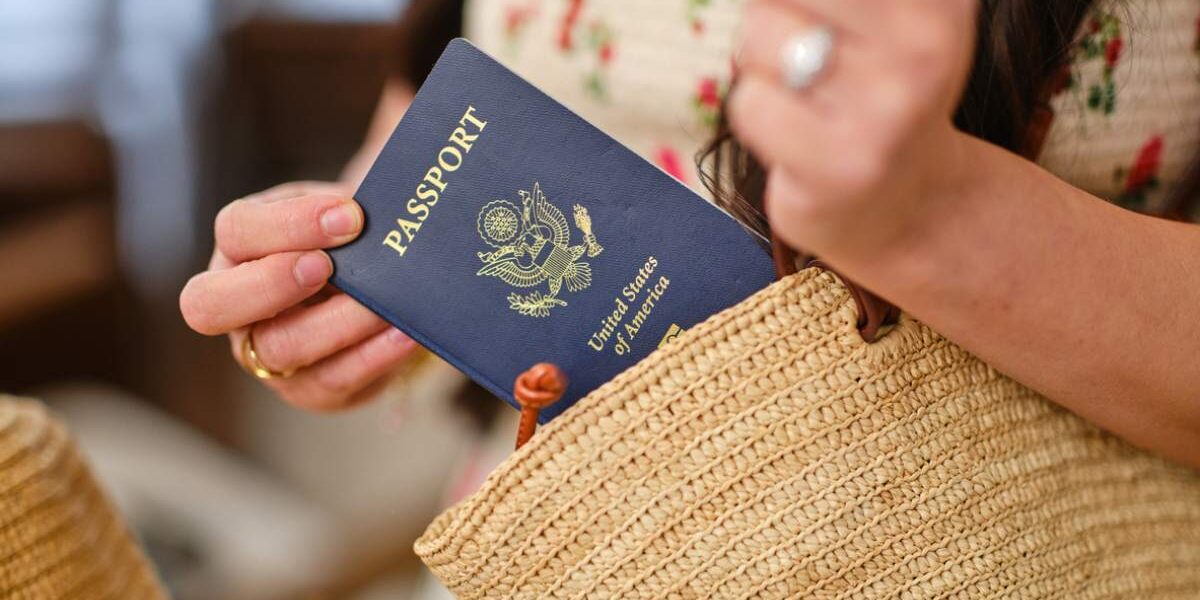 a woman reaching for her US passport which is linked to her ETIAS application for Europe