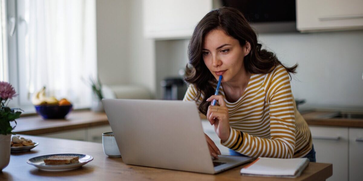 a woman applying for the UK ETA on her laptop at home